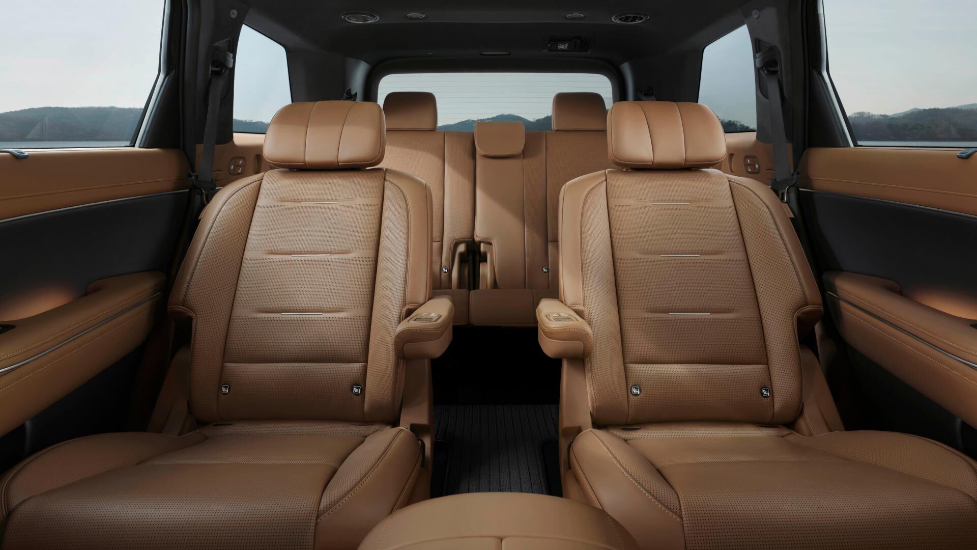 Side-front view of orange Grandi10 with lakeside view at night